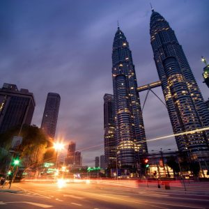 Beautiful long exposure of Kuala Lumpur at night showcasing iconic Petronas Towers and urban lights.